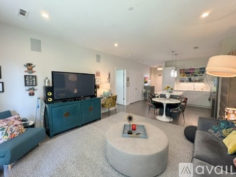 A living room with a grey couch and a green cabinet.