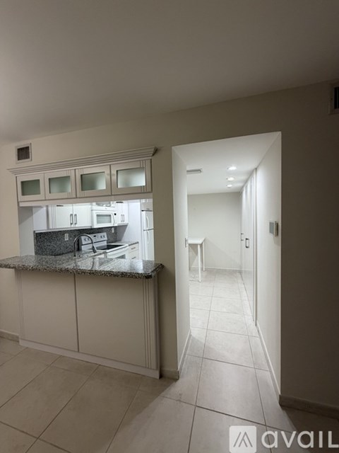 A kitchen area with a counter and cabinets.
