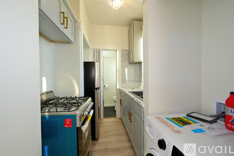 A kitchen with a blue fridge and a white counter top.