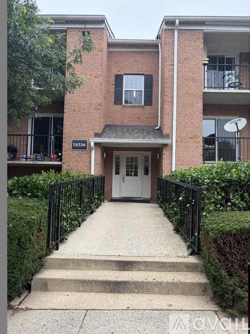 The front steps lead to the entrance of a brick building with the number 18336 on it.