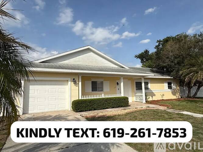 A house with a white garage door and a phone number on the image.