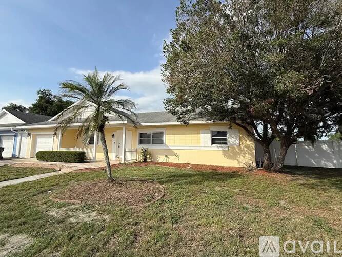 A house with a tree in front of it.