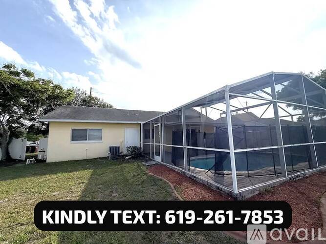 A house with a pool enclosed by a glass wall and a phone number is displayed.