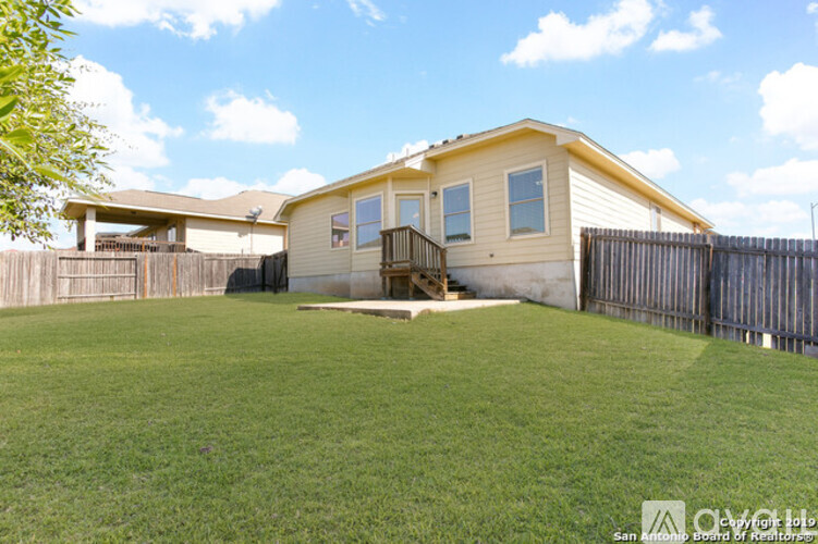 A house with a fenced backyard.