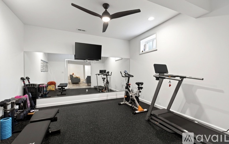A well-equipped home gym with a variety of exercise equipment.