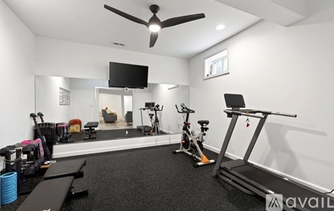 A well-equipped home gym with a variety of exercise equipment.