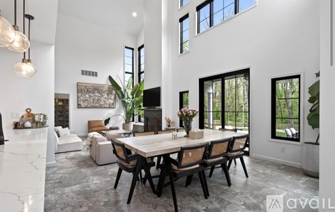 A modern dining room with a large table and chairs.