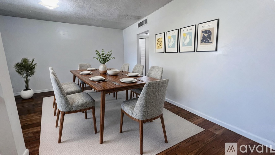 A dining room with a wooden table and chairs.