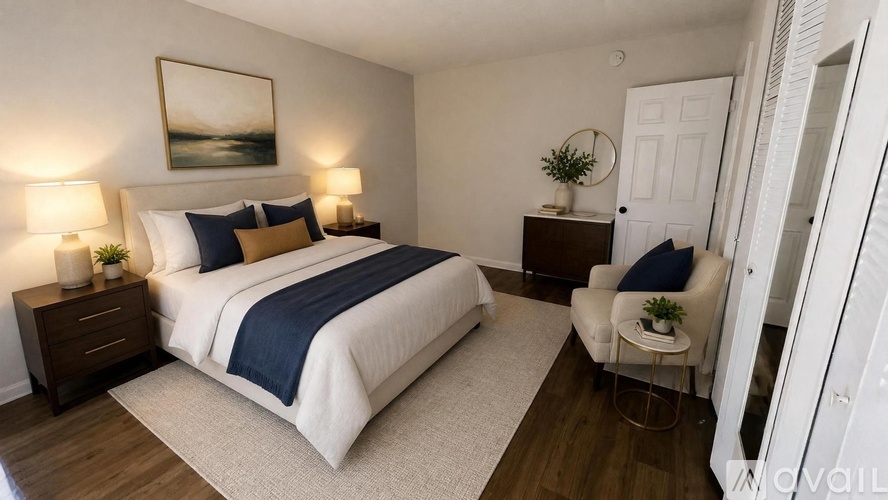 A bedroom with a large bed and a painting on the wall.