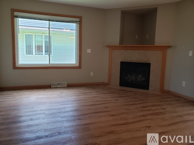 A room with a fireplace and a window.