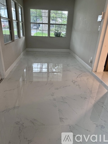 A room with a marble floor and a window.