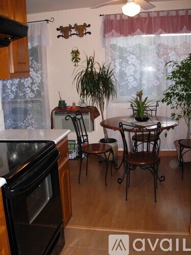 A kitchen with a table and chairs in front of a window.