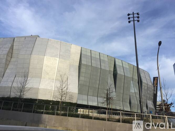 A modern building with a glass facade and a street light in front.