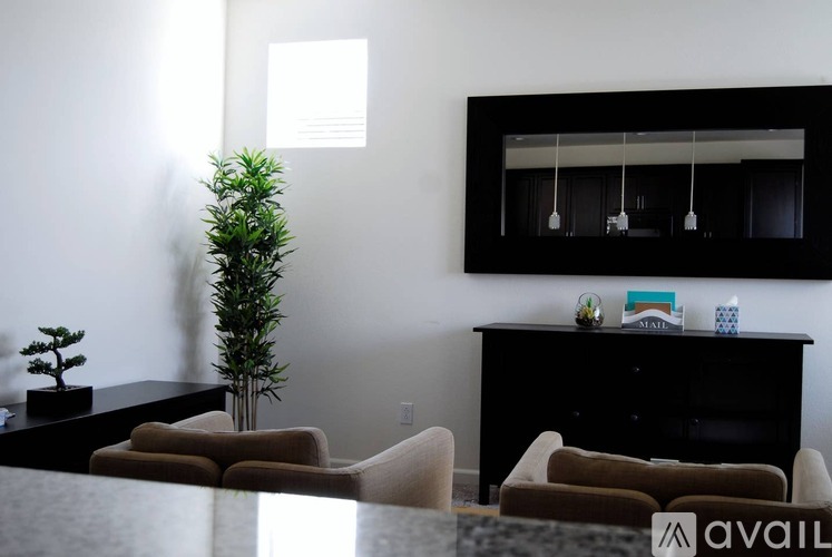 A living room with a black cabinet, a mirror, and two couches.