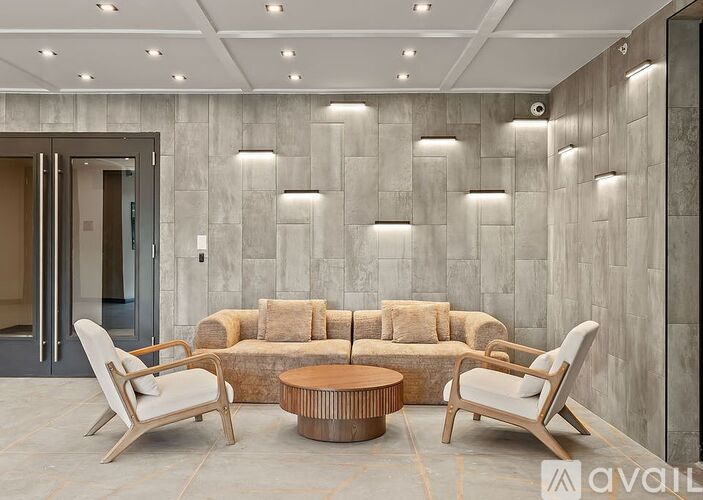 A modern living room with a grey stone wall and a wooden coffee table.
