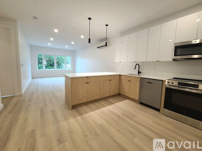 A kitchen with wooden floors and white cabinets is available for rent.