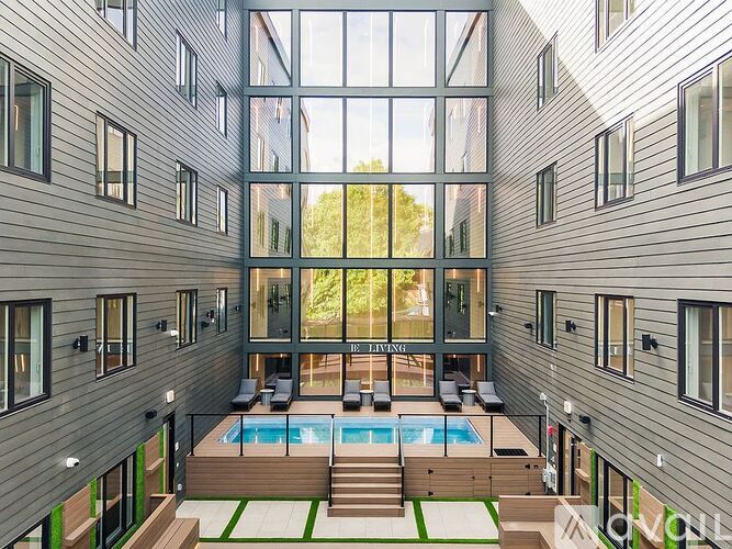 A modern house with a pool in the middle of the living room.