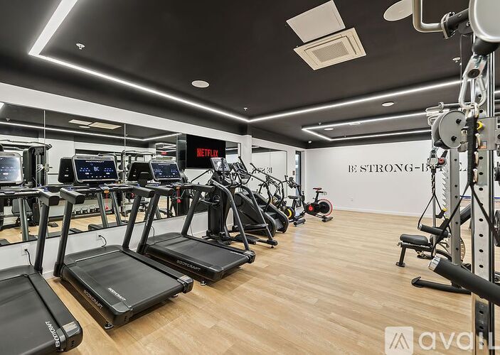 A gym with treadmills, exercise bikes, and other equipment.