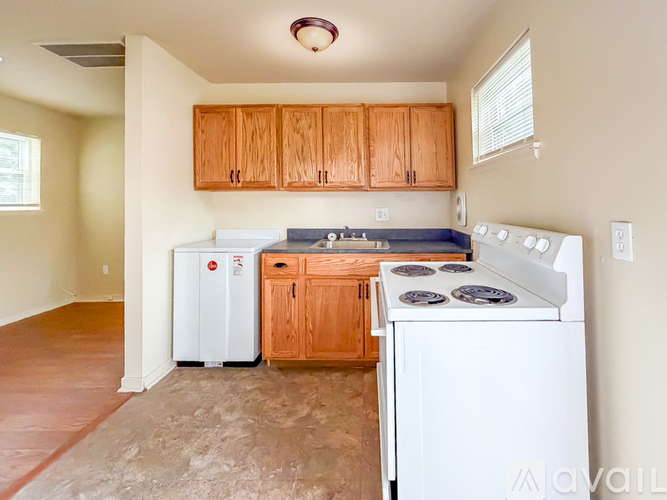 A kitchen with wooden cabinets and white appliances.