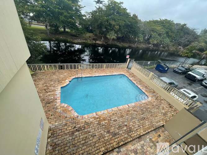 A small above ground pool surrounded by a brick border.