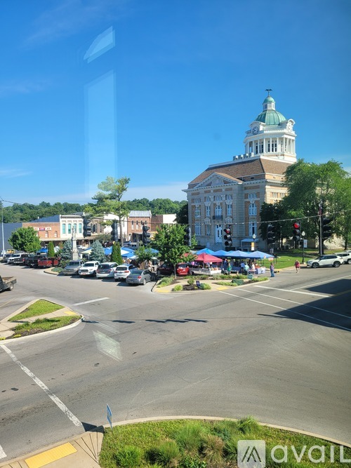 A street view of a town with a church in the background.