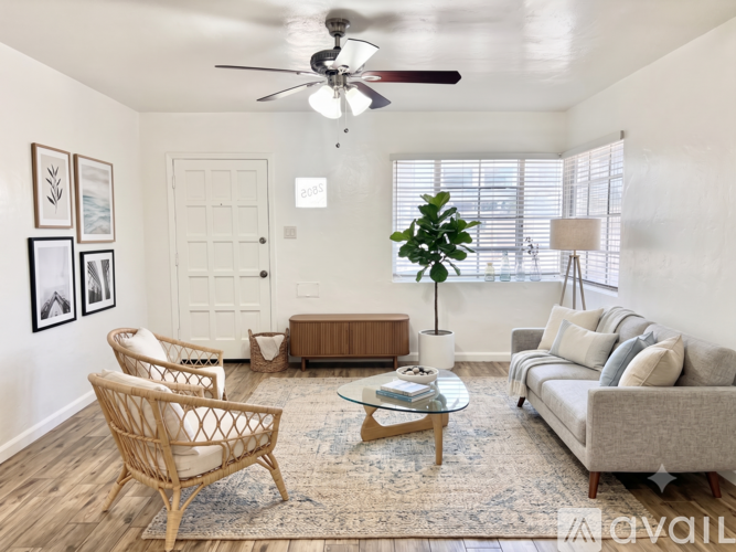 A living room with a ceiling fan and a couch.