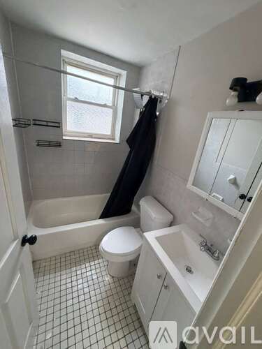 A bathroom with a toilet, sink, and bathtub.
