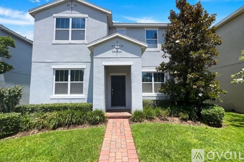 A house with a grey exterior and a black front door.