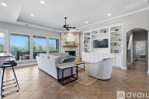 A living room with a white couch and a ceiling fan.