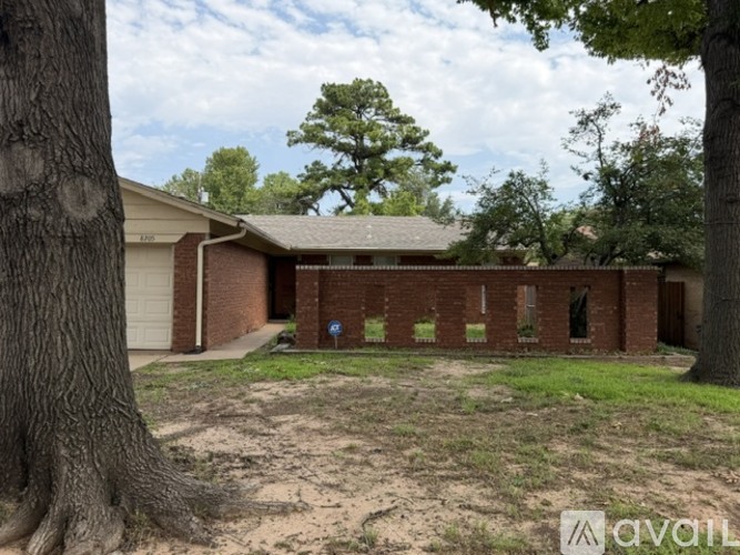 A house with a tree in front of it.