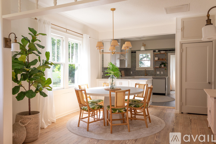 A dining room with a round table and chairs.