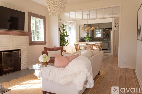 A living room with a white couch and a fireplace.