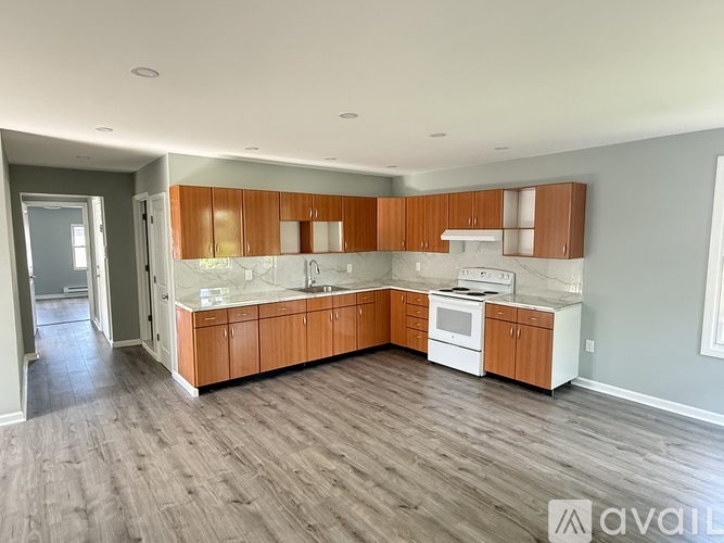 A kitchen with wooden cabinets and a white countertop.