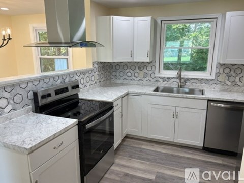 A kitchen with a marble countertop and a stove top oven.