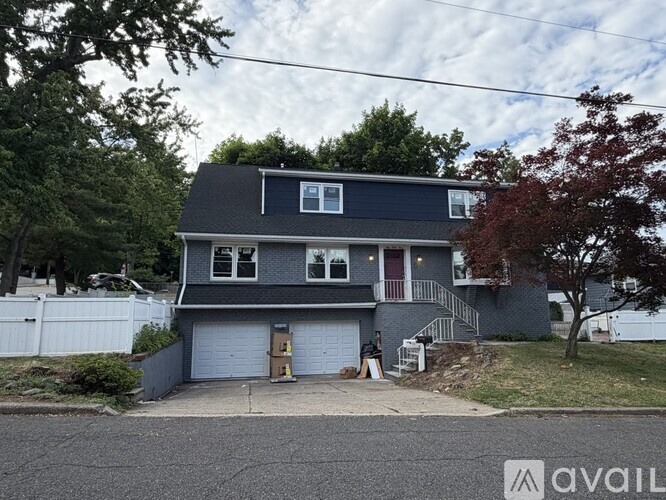 A two-story house with a garage is for sale.