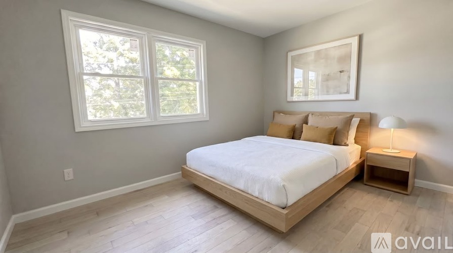 A bedroom with a large bed and a window.