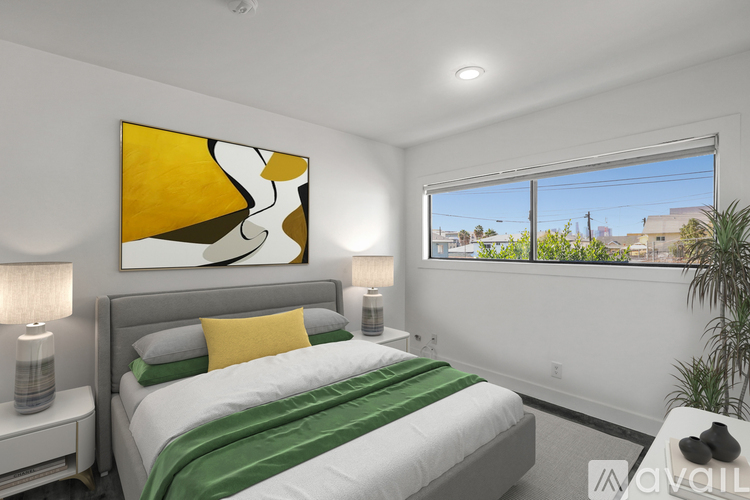 A bedroom with a large bed and a painting on the wall.