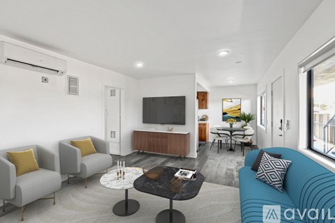 A living room with a blue couch and a television.