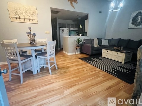 A living room with a dining table and chairs.