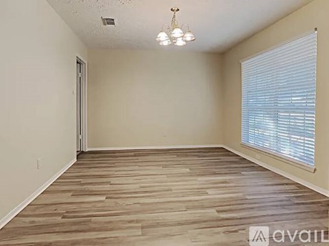 A kitchen with wooden cabinets and white appliances.