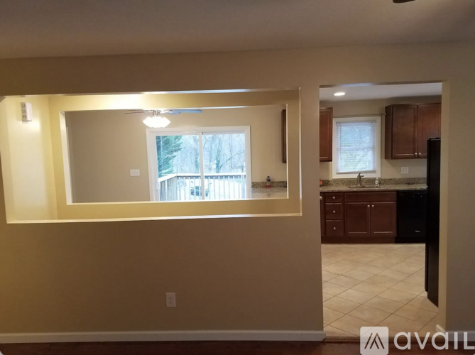 A room with beige walls and a large window.