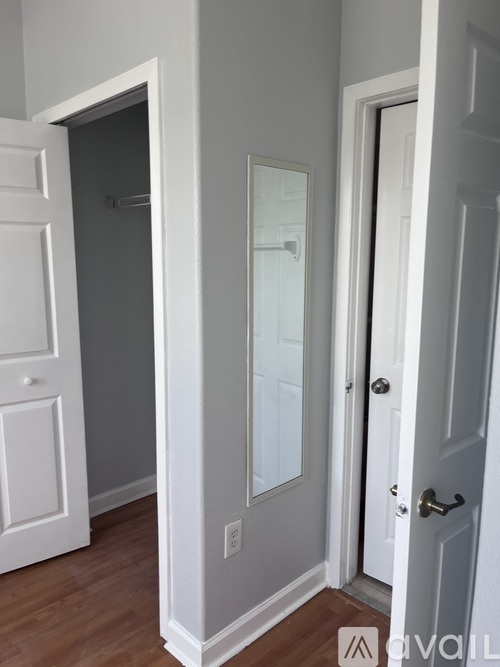 A white door is open to a hallway.