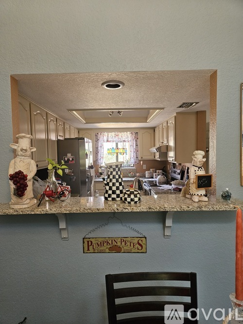 A kitchen with a counter that has a sign that says "Pumpkin Pete's" on it.