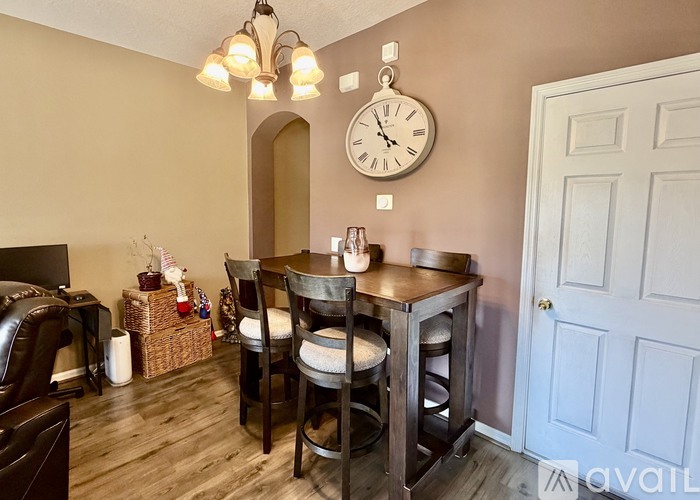 A dining room with a wooden table and chairs.