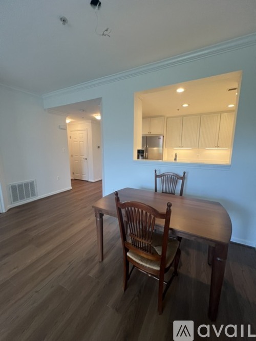 A dining room with a wooden table and chairs.