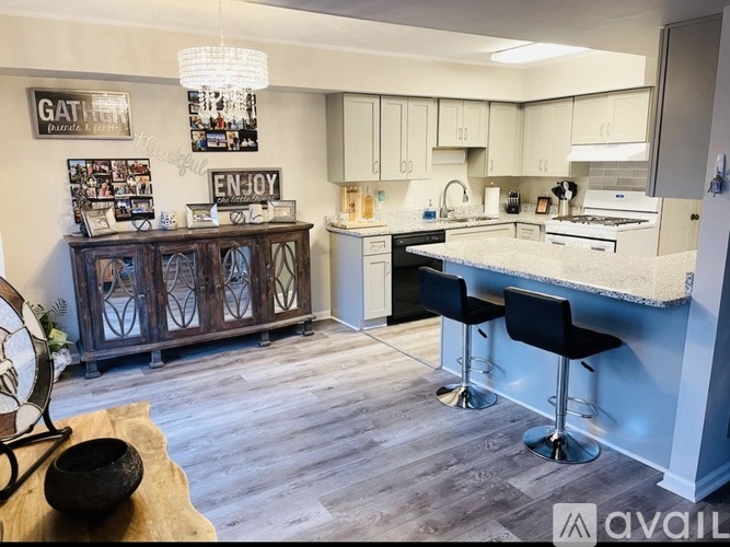 A kitchen with a bar area and a sign that says "ENJOY".