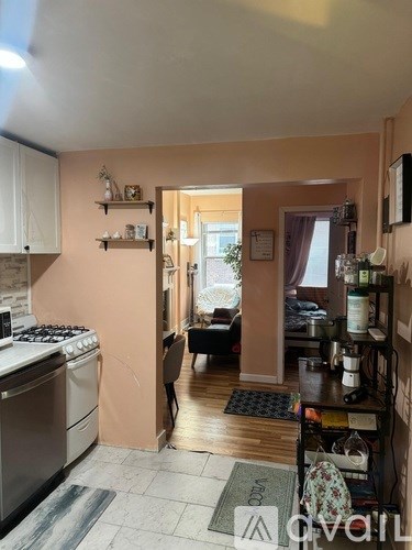 A kitchen with a stove, oven, and a dining table with chairs.
