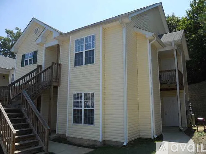 A two-story house with a balcony on the upper floor.