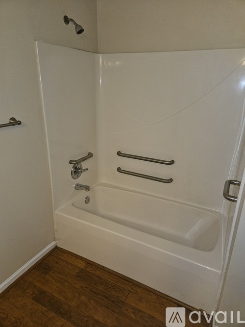 A white bathtub with silver fixtures in a bathroom.