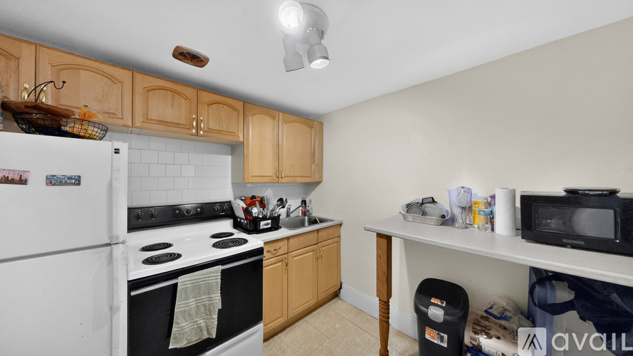 A kitchen with wooden cabinets and a white refrigerator.